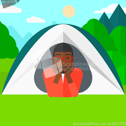 Image of Man lying in tent.