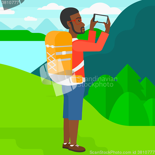 Image of Backpacker taking photo.