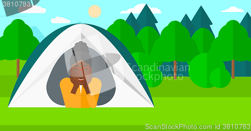 Image of Woman lying in tent.