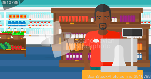 Image of Salesman standing  at checkout.