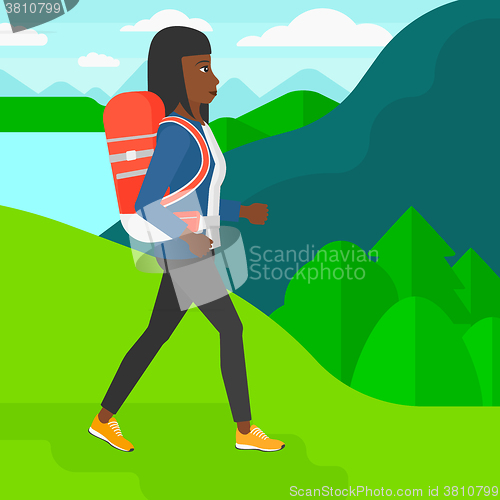 Image of Woman with backpack hiking.