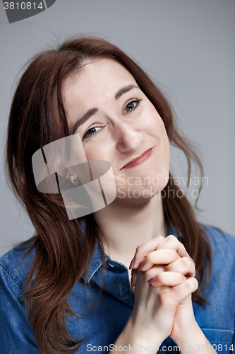 Image of Woman is looking imploring over gray background