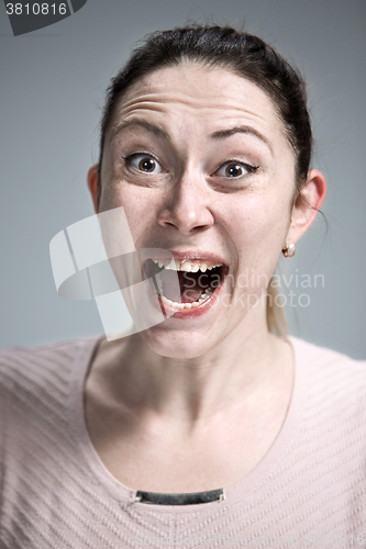 Image of Portrait of young woman with shocked facial expression