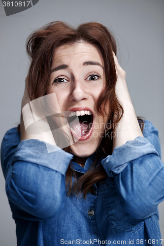 Image of Portrait of young woman with shocked facial expression