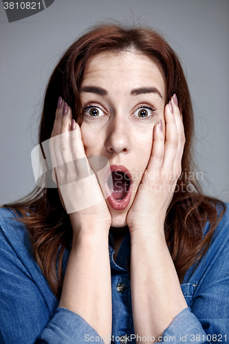 Image of Portrait of young woman with shocked facial expression