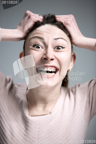 Image of Portrait of young woman with shocked facial expression