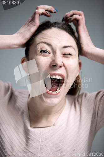 Image of Portrait of young woman with shocked facial expression