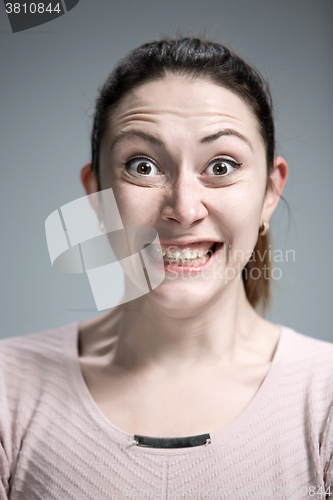 Image of Portrait of young woman with shocked facial expression