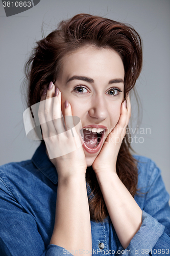 Image of Portrait of young woman with shocked facial expression