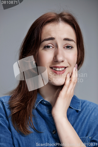 Image of Woman is looking imploring over gray background