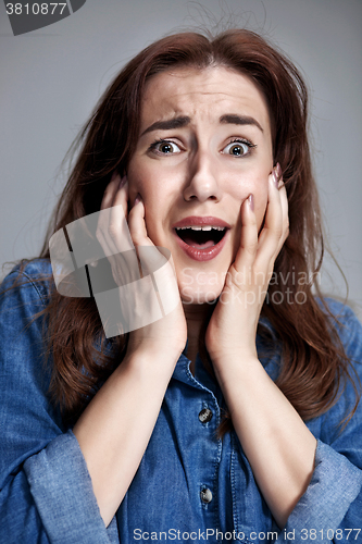 Image of Portrait of young woman with shocked facial expression