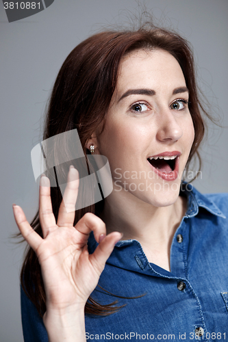 Image of The happy woman on gray background