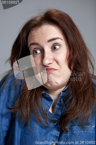 Image of Portrait of young woman with shocked facial expression