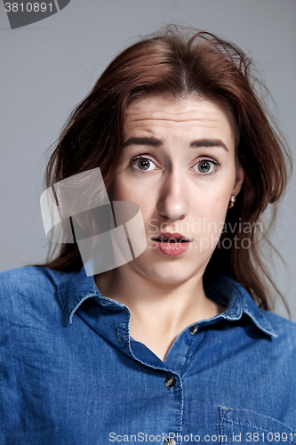 Image of Portrait of young woman with shocked facial expression