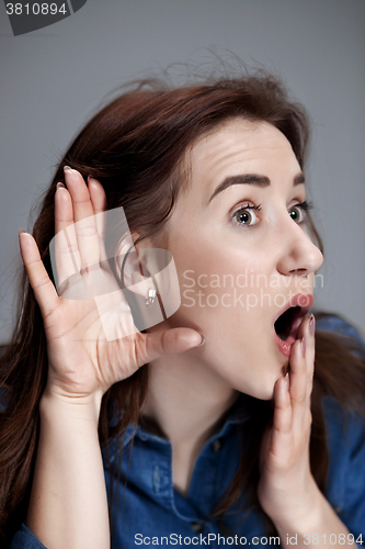 Image of Young woman trying to listen something