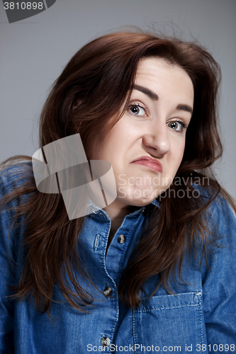 Image of Portrait of young woman with shocked facial expression