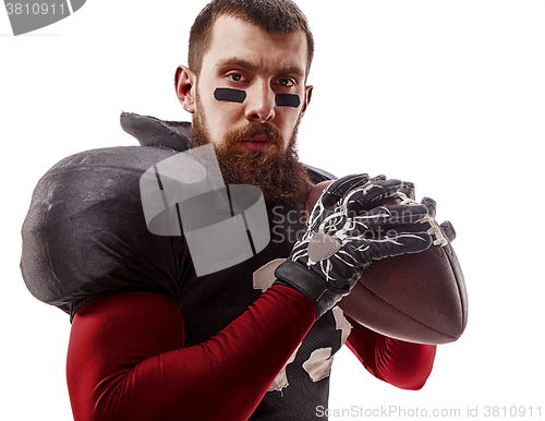 Image of American football player posing with ball on white background