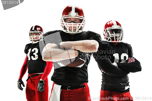 Image of The three american football players posing with ball on white background