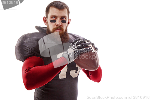 Image of American football player posing with ball on white background