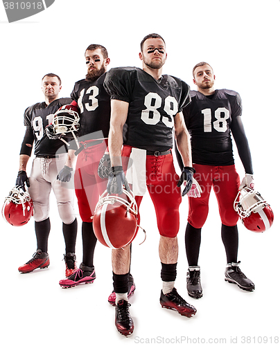 Image of The four american football players posing with ball on white background