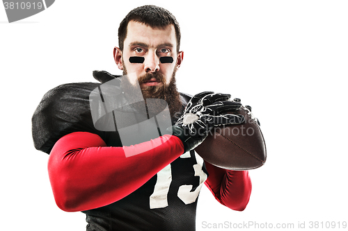 Image of American football player posing with ball on white background