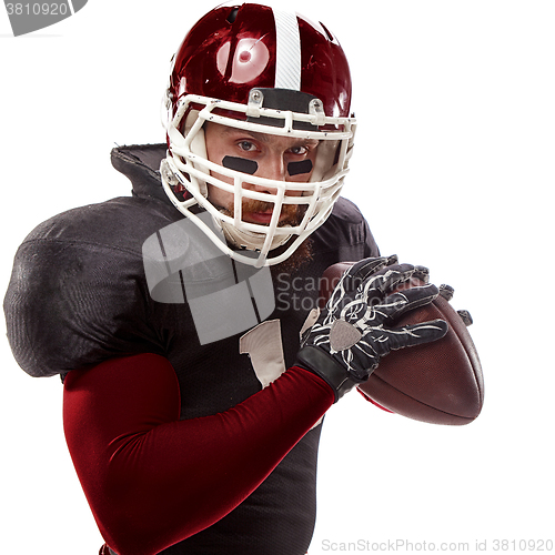 Image of American football player posing with ball on white background