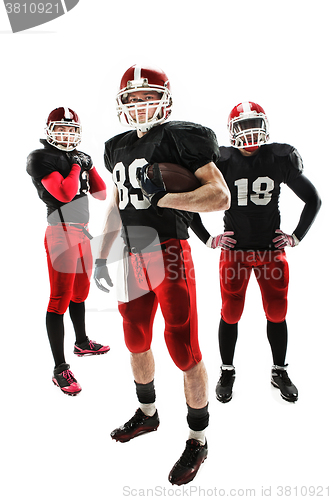 Image of The three american football players posing with ball on white background