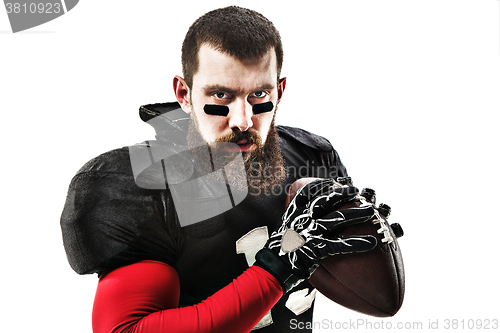 Image of American football player posing with ball on white background