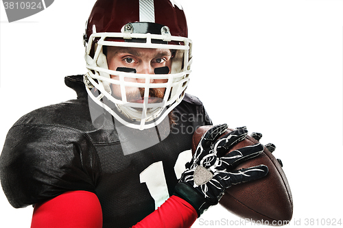 Image of American football player posing with ball on white background