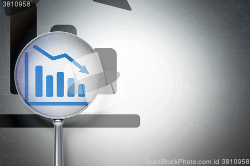 Image of Marketing concept:  Decline Graph with optical glass on digital background