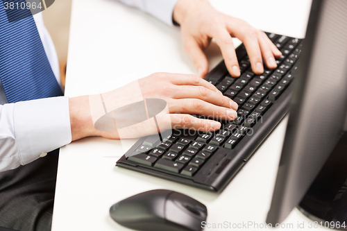 Image of close up of businessman hands typing on keyboard