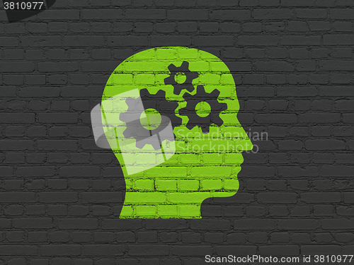 Image of Advertising concept: Head With Gears on wall background