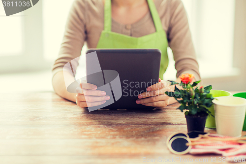 Image of close up of woman or gardener holding tablet pc