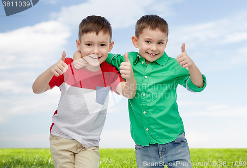 Image of happy smiling little boys showing thumbs up