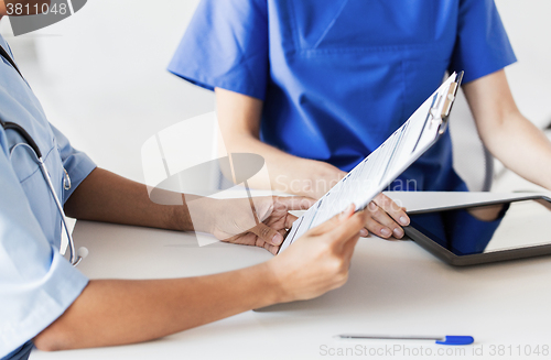 Image of close up of doctor with medical report at hospital