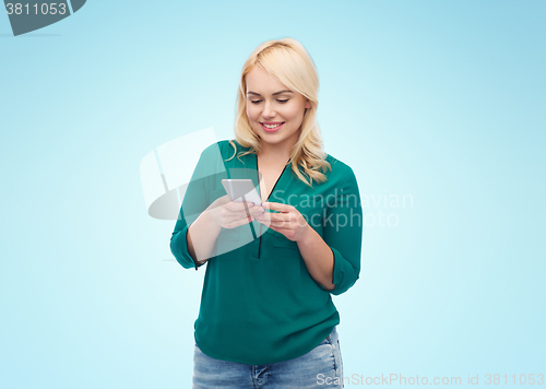 Image of happy woman with smartphone texting message