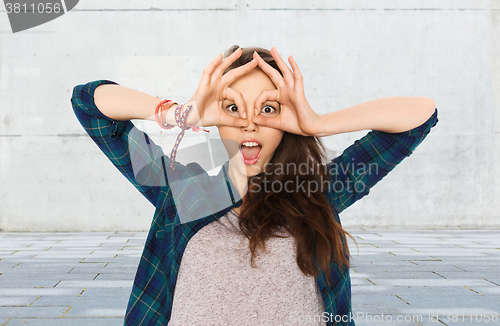 Image of happy teenage girl making face and having fun