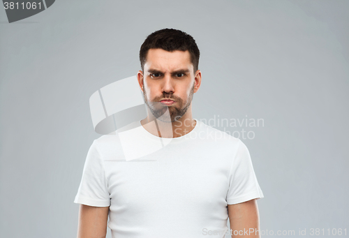 Image of man with funny angry face over gray background