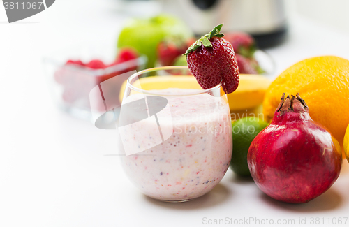 Image of close up of glass with milk shake and fruits