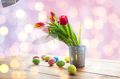 Image of close up of easter eggs and flowers in bucket