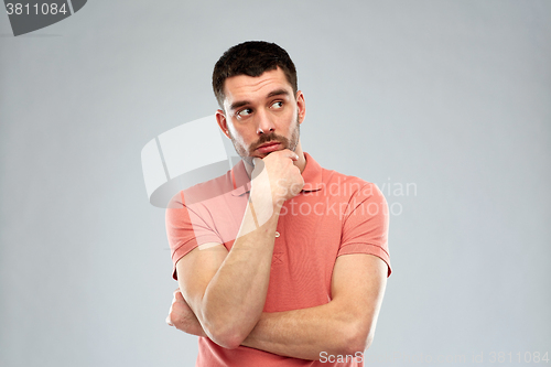 Image of man thinking over gray background