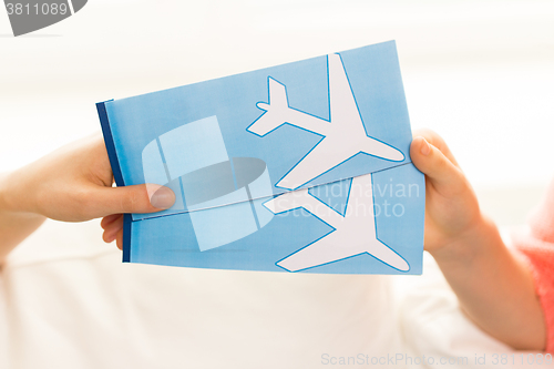 Image of close up of hands with airplane tickets