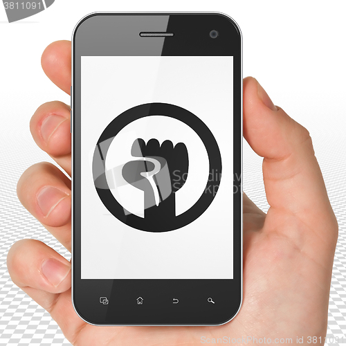 Image of Politics concept: Hand Holding Smartphone with Uprising on display