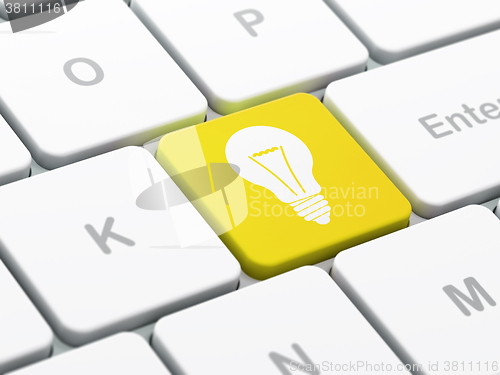 Image of Finance concept: Light Bulb on computer keyboard background
