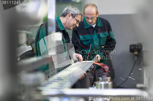 Image of Industrial worker grinding in manufacturing plant.