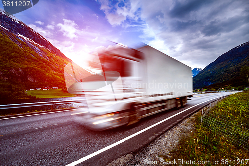 Image of Truck and highway at sunset