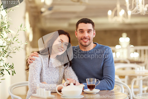 Image of happy couple drinking tea at restaurant