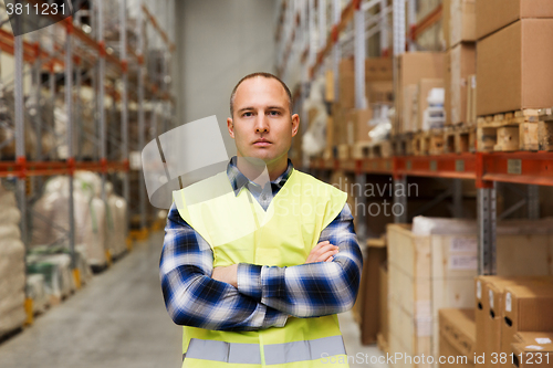 Image of man in reflective safety vest at warehouse