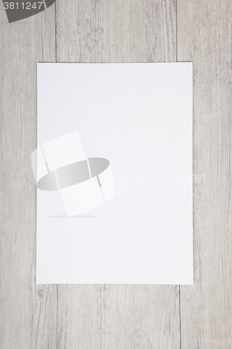 Image of white paper on wood background