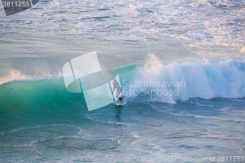 Image of Senior surfer riding a perfect wave.